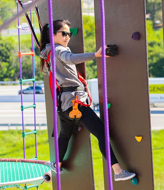 girl climbing on the RYZE climbing tower