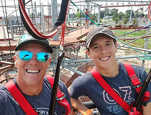 Dad and son playing on the Adventure Tower together during a special event for fathers day