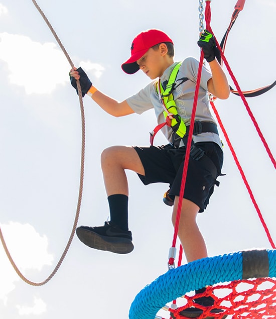 A young boy on the ropes course at RYZE