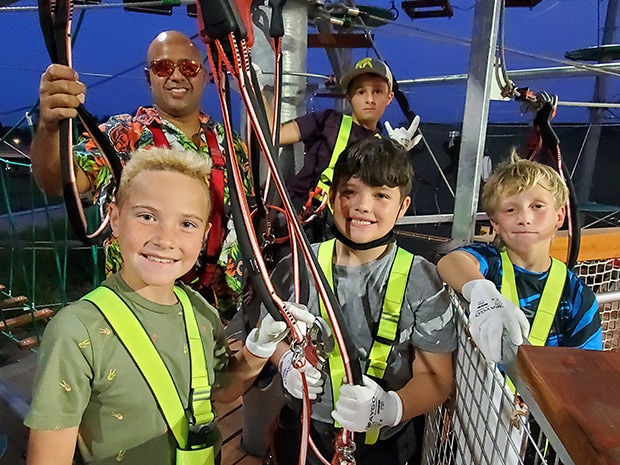 A Boy Scout group of young boys posing for a picture after conquering the challenge course