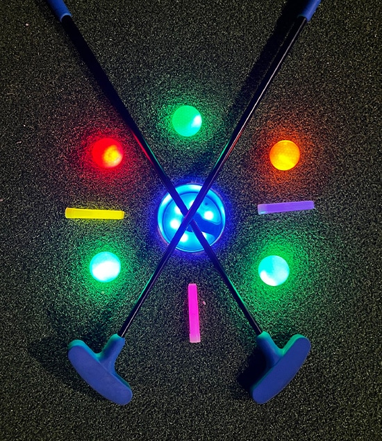 glow in the dark mini golf balls and mini golf hole with putters at Ryze