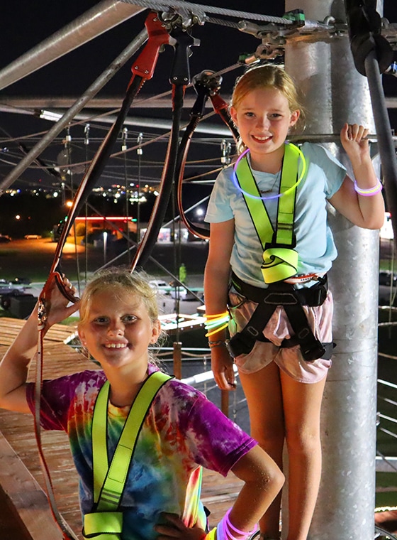 2 kids on tower on glow night