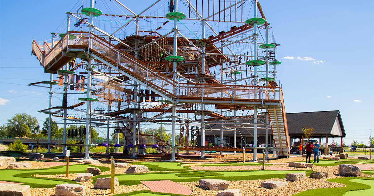 The adventure tower at Ryze Adventure Park that includes rope courses and ziplining, mini golf is in the foreground