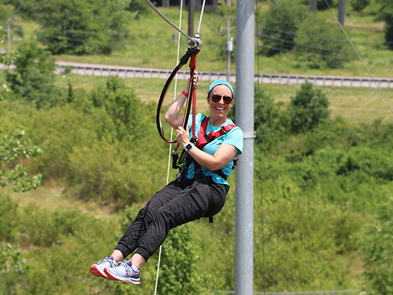 Mom soaring on the zipline at an Event at RYZE Adventure Park