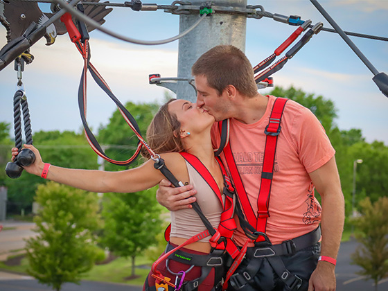 couple kissing during date night event on ropes course