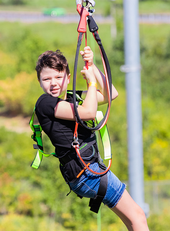 young boy ziplining at a birthday party in Maryland Heights, MO