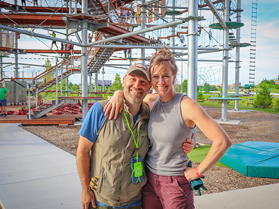 husband and wife excited after completing the ropes course and zipline