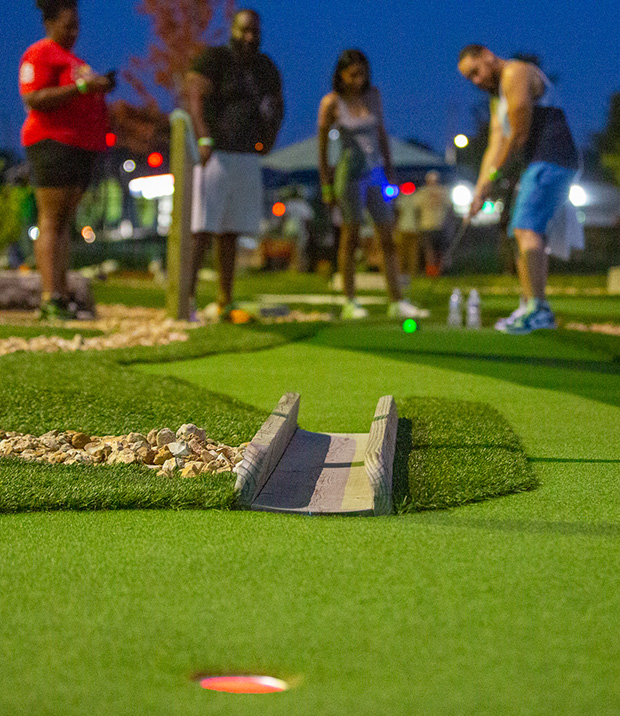 2 couples playing glow golf in St Louis County