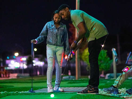 Dad and daughter playing glow golf