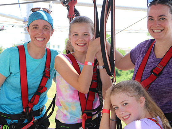 Family posing for a photo on the ropes course in st. louis