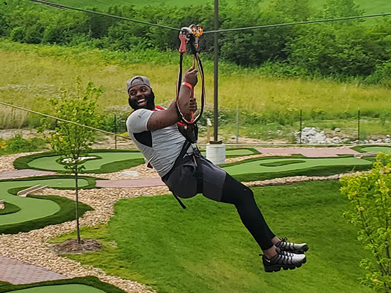 Mom smiling with 2 boys after completing the zipline and ropes course